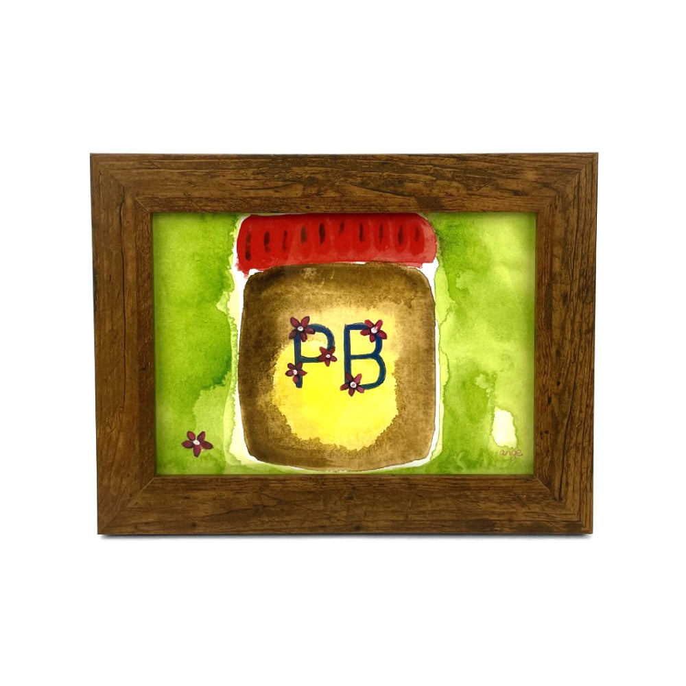 Framed artwork of a peanut butter jar with 'PB' letters on a green background on a white backround.