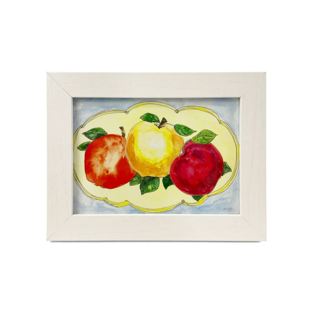 A framed watercolor painting of three apples on a light blue background, enclosed in a white wooden frame.