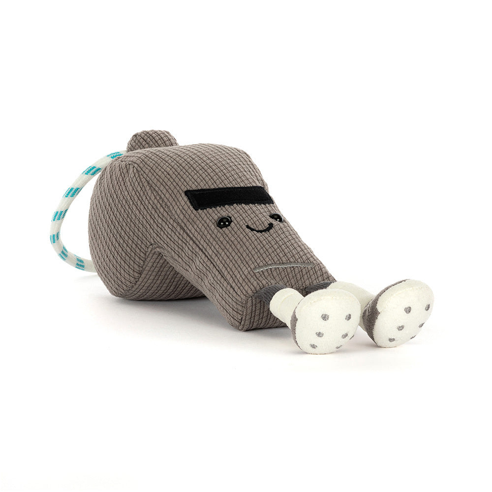 Plush toy resembling a whistle with a smiling face on a white background
