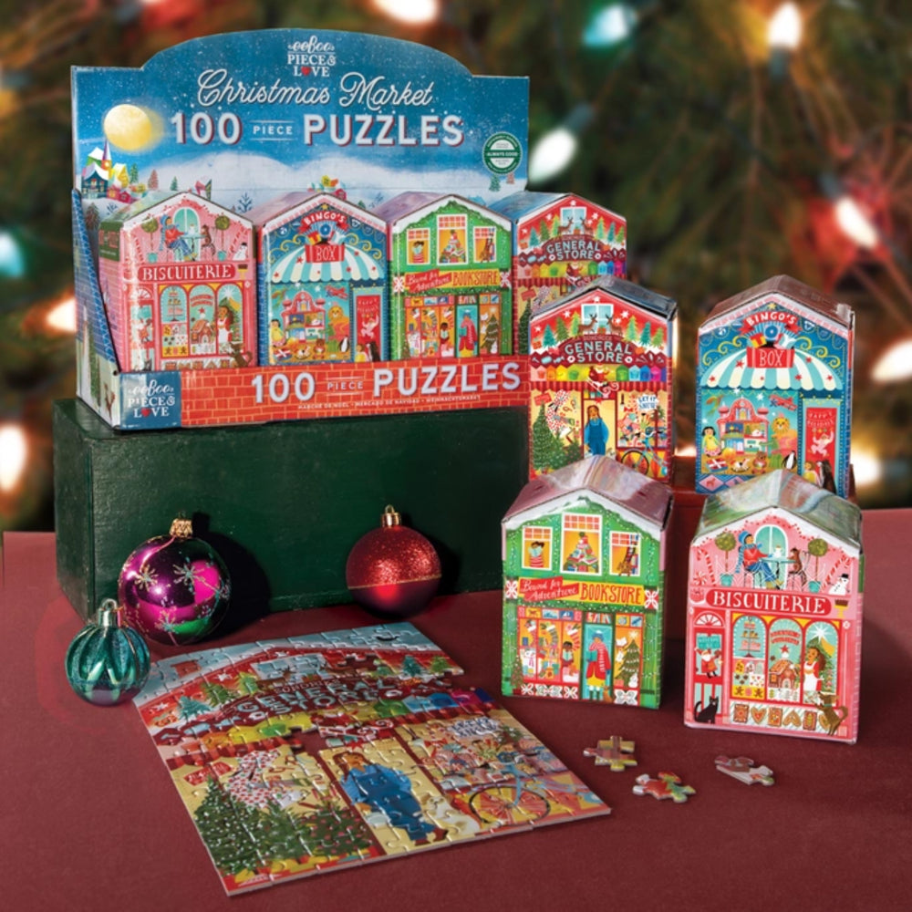 Christmas market-themed puzzle set with packaging and completed puzzle on a table.