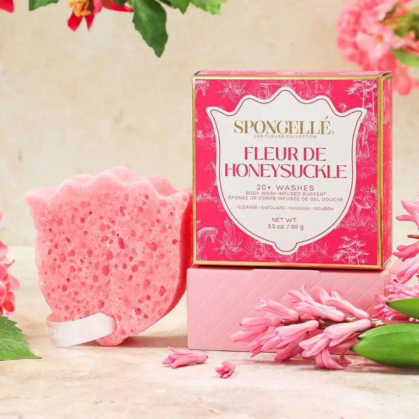 Pink bath sponge and packaging with floral elements on a light background