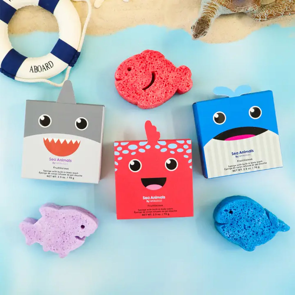 Three cartoon-style bath bombs with packaging on a blue background, featuring sea animal designs.
