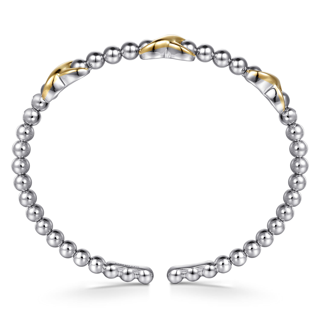 Two-toned beaded bracelet with gold and silver accents on a white background