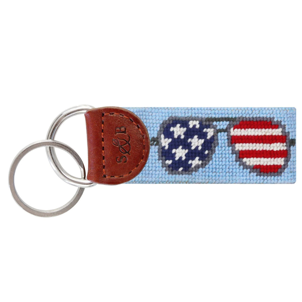Keychain with heart designs in American flag and aviator pattern on a light blue background on key fob.