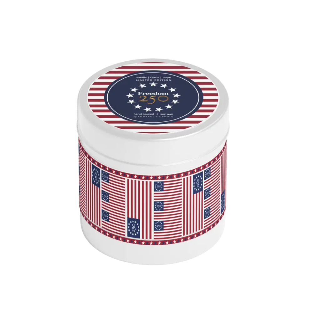 White candle jar with American flag design and 'Freedom 250' label on a white background.