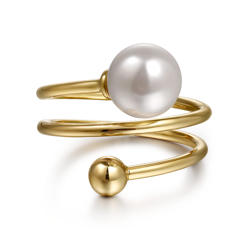 Gold ring with a pearl on a white background