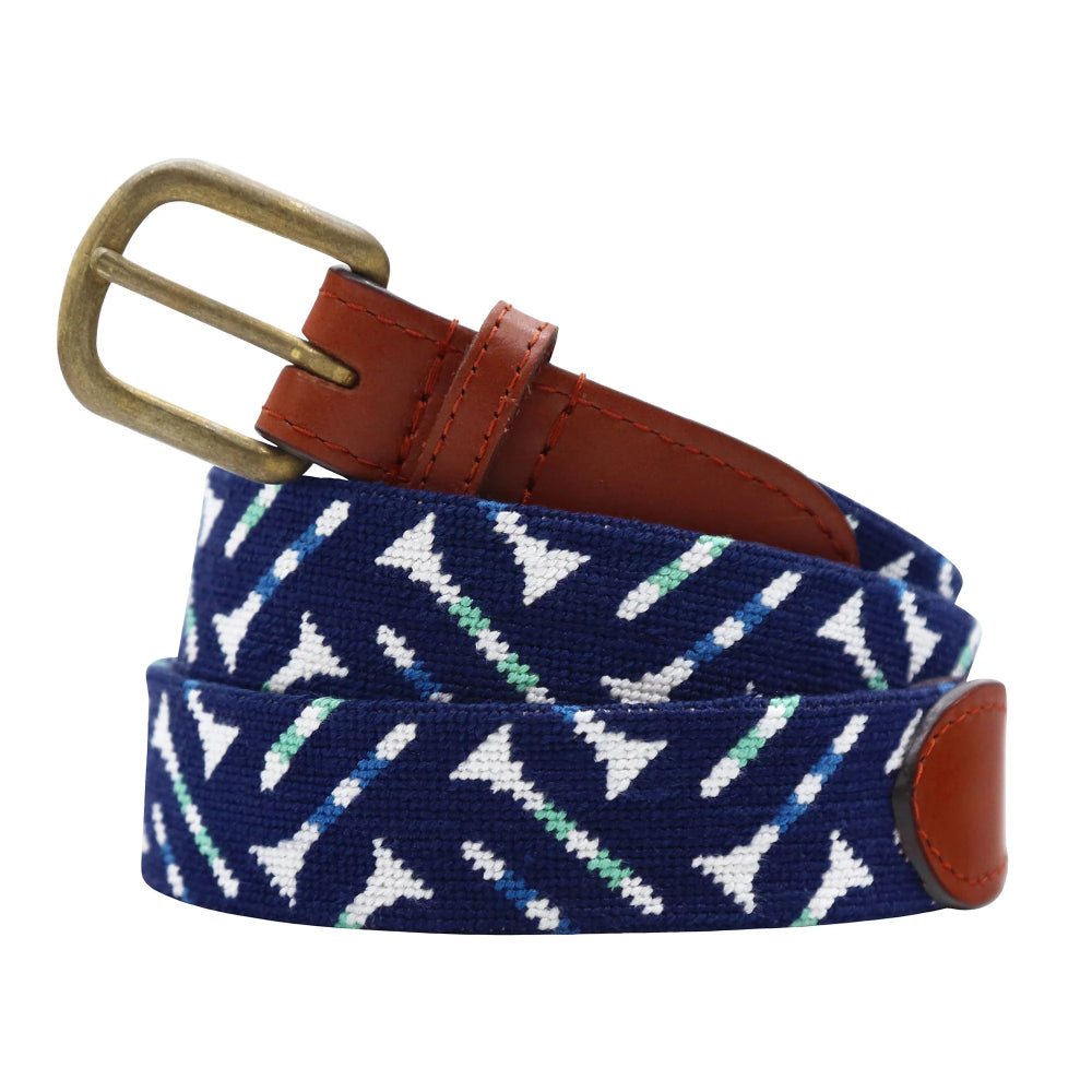 Navy belt with white golf tee pattern and brown leather buckle on a white background