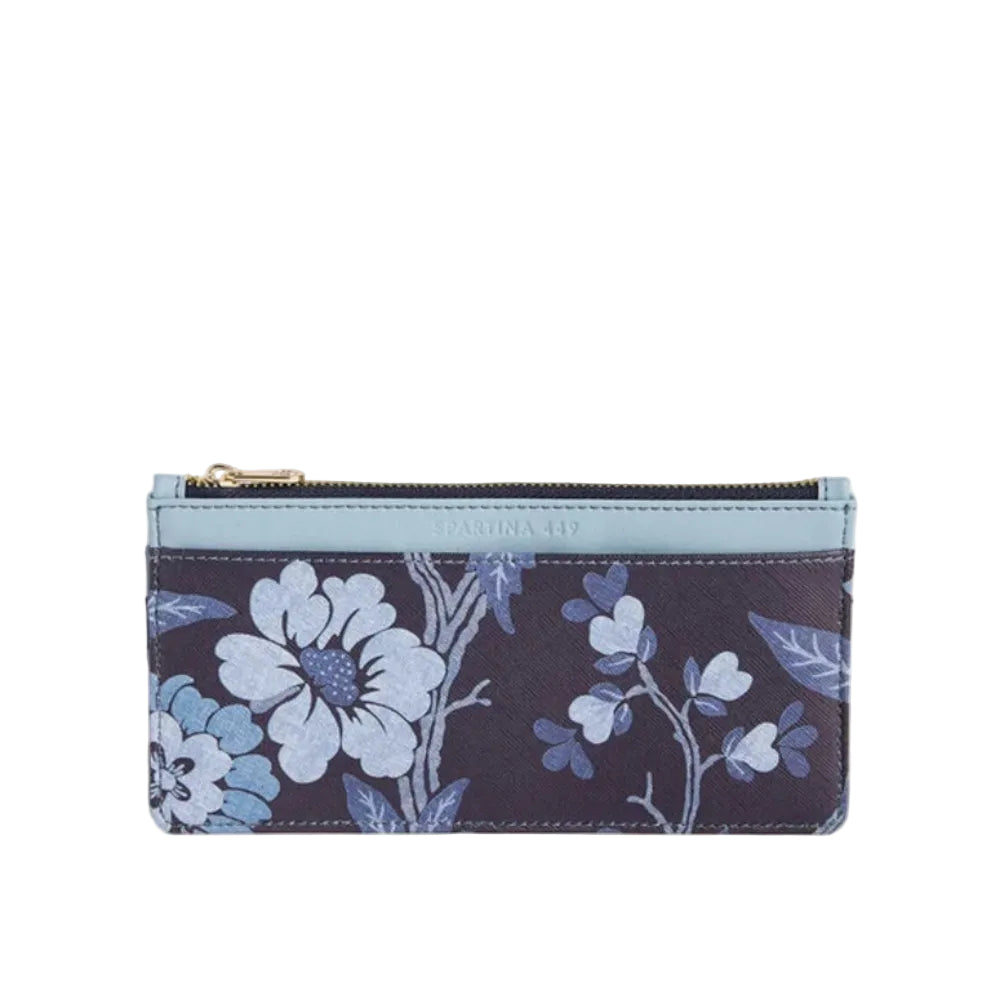 A slim zip pouch with a floral print on a dark navy background, featuring light blue and white flowers, a light blue top border, and a gold zipper pull.