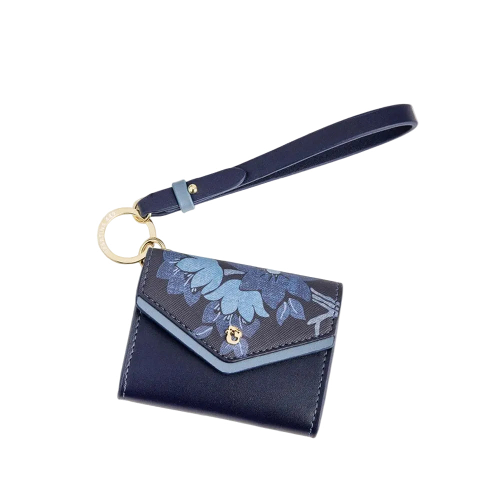 A navy blue leather wallet with a matching wrist strap, featuring a blue floral pattern on the flap and gold-tone hardware.