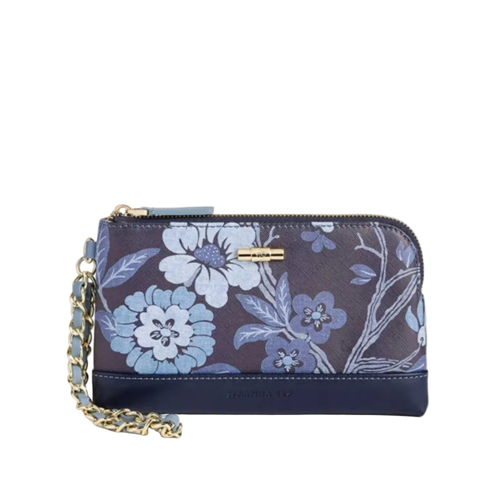 A navy blue zip-around clutch wallet featuring a light blue and white floral pattern on the front, with a navy blue leather base, a gold-tone metal bar detail, and a gold-and-blue chain strap, set against a solid light beige background.