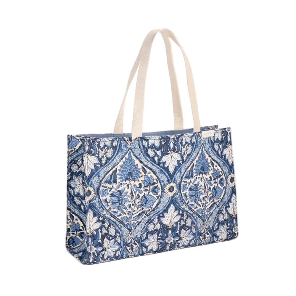 Blue floral printed canvas tote bag with beige handles on a white background