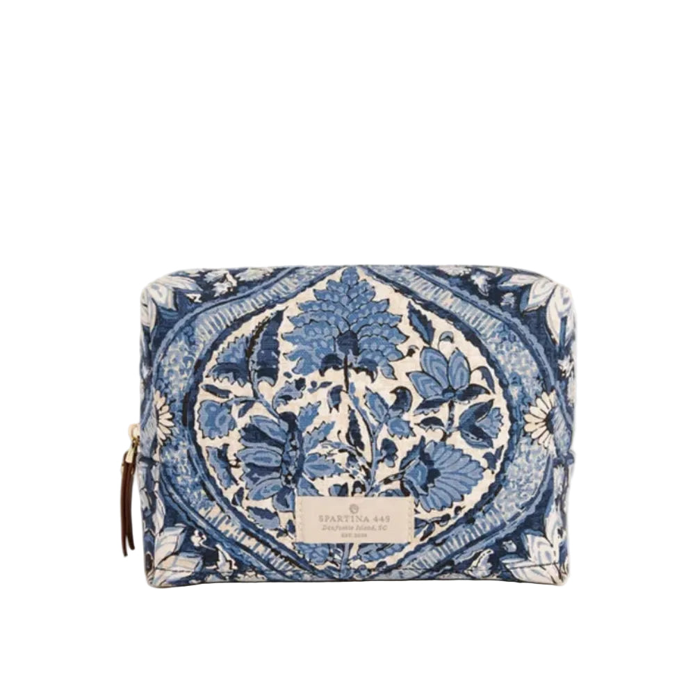 A small zippered pouch with a blue and cream floral damask pattern, featuring a small gold-tone zipper pull and a silver-tone metal brand plaque on the front.