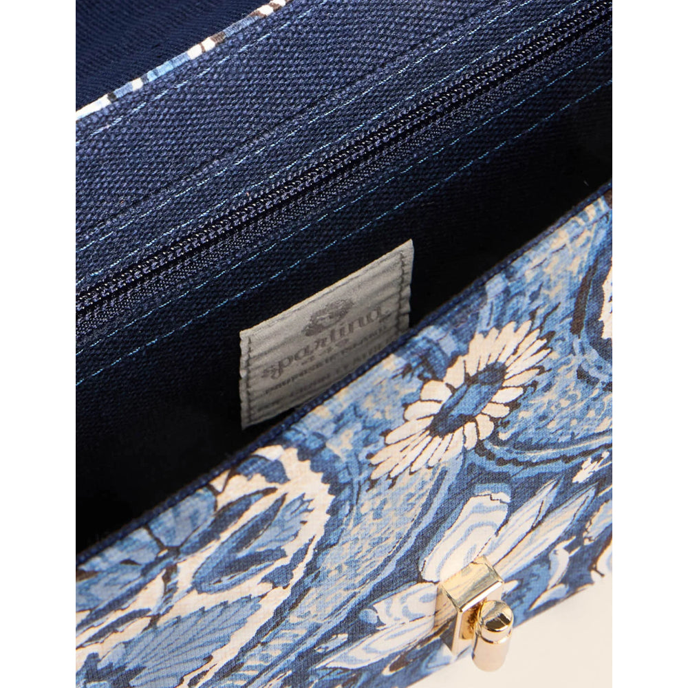 Close-up of a blue patterned clutch or pouch with a gold-tone clasp and a visible interior label reading 'sophia', shown against a white background.