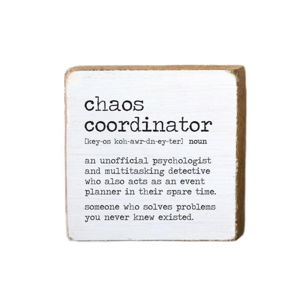 White wood decorative square block sign with the definition of 'chaos coordinator' "An Unofficial Psychologist And Multitasking Detective Who Also Acts As An Event Planner In Their Spare Time. Someone Who Solves Problems You Never Knew Existed" in black text on a on a white background