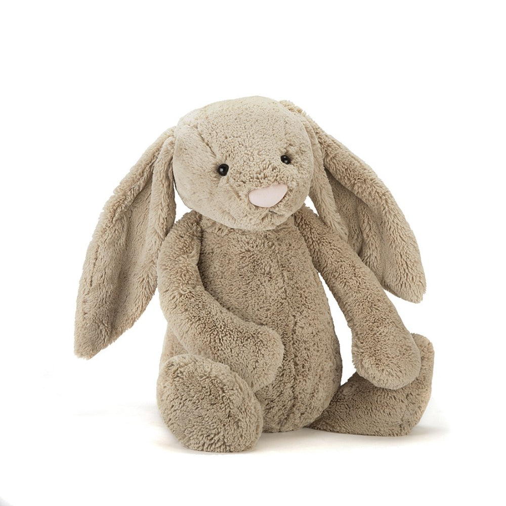 A big size  beige plush toy in the shape of a bunny with long floppy ears, a small pink nose, and a soft fur texture on a white backround 