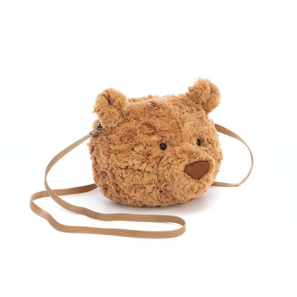 A plush bear-shaped cross-body bag with a brown maple-syrup color, petal-fold ears, and a sturdy silver zipper. The bag has a caramel lining and a long strap.
