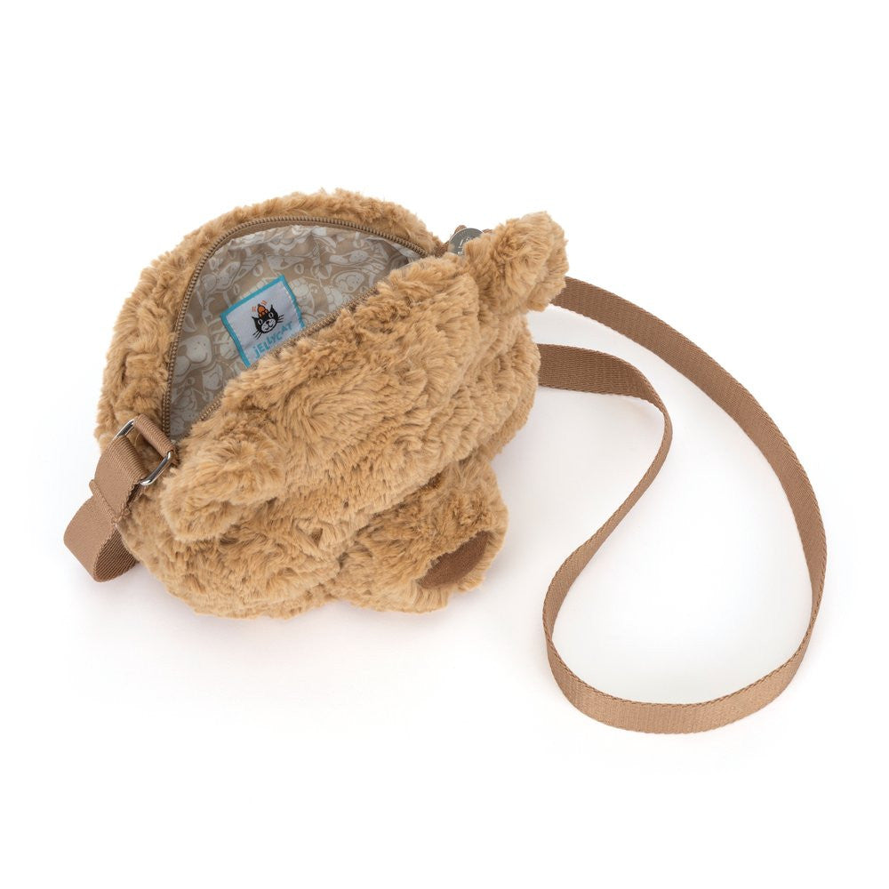 Brown plush bag with a strap on a white background