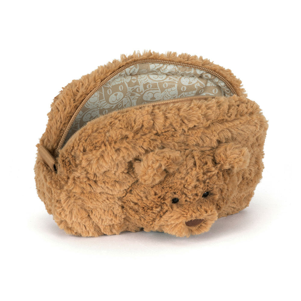 A photo showing the opened zipperd top opening of a brown teddy bear-shaped pouch with a zipper on a white background.
