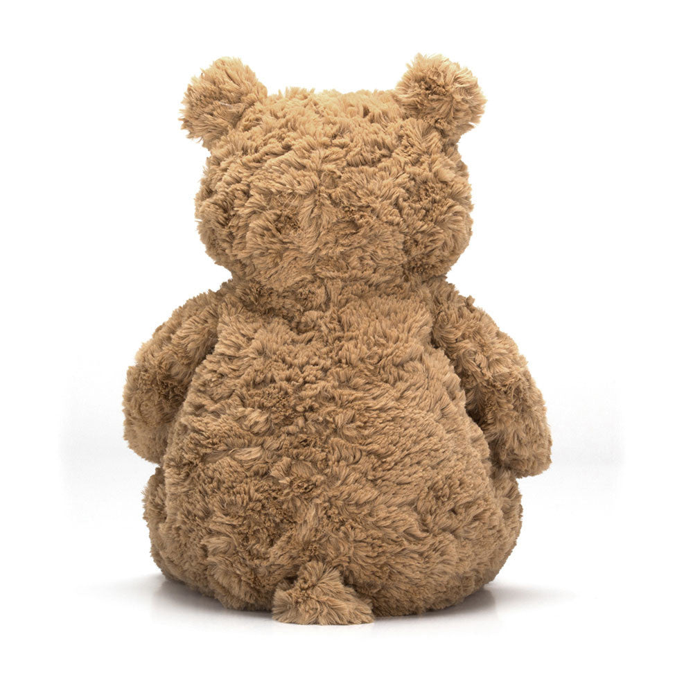 A photo of the back of a huge size beige teddy bear  sitting upright on a white backround.