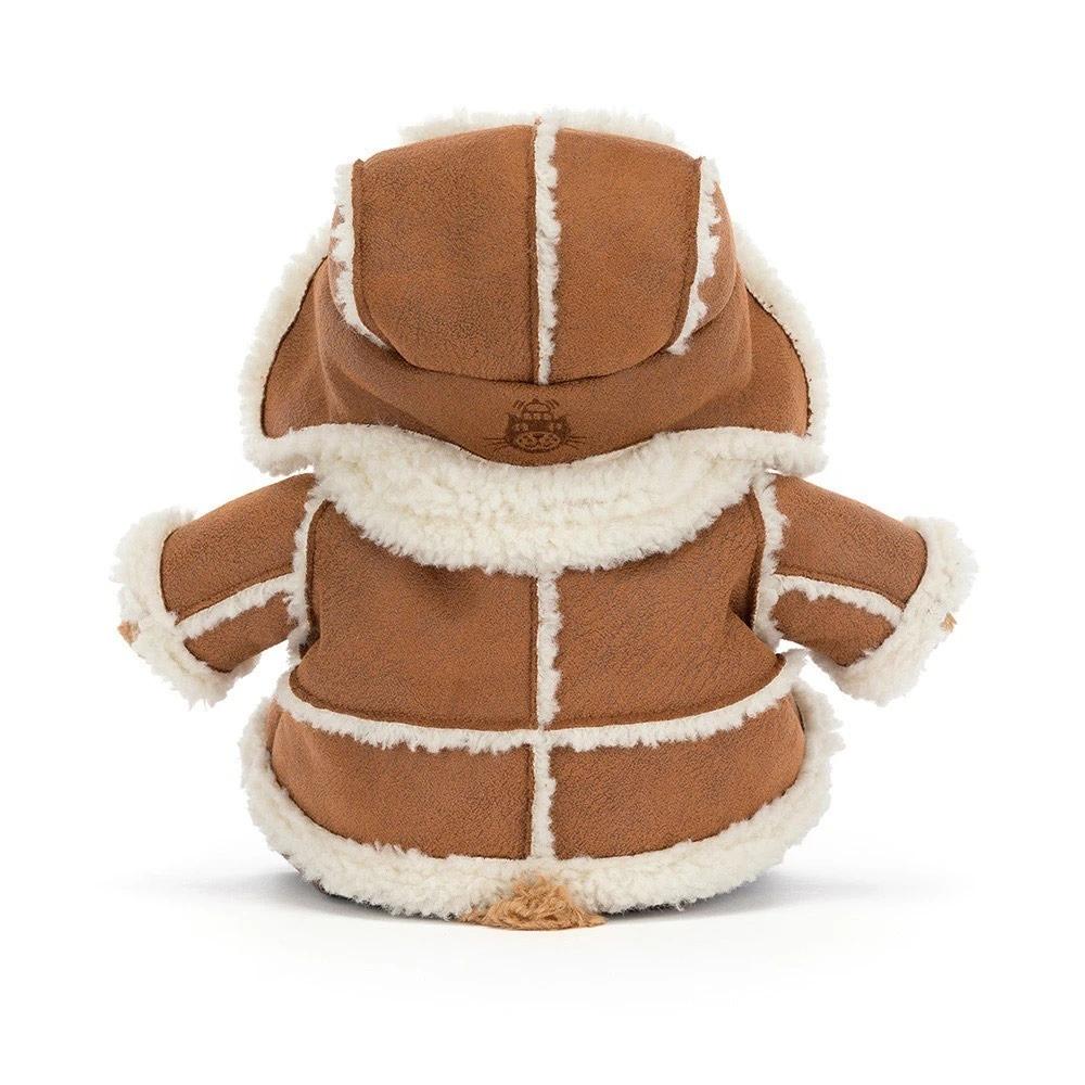 The back of a plush teddy bear dressed in a brown suede-like winter coat with cream sherpa lining and a dark brown bootie underneath, photographed on a clean white background.