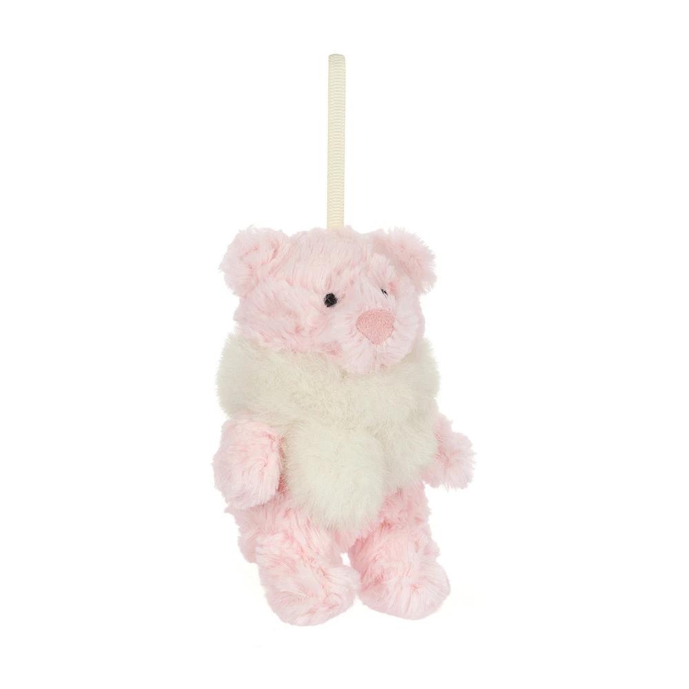 A small pink plush hanging bear ornament in soft pink and cream white faux fur, suspended by a cream ribbon on a plain white background.
