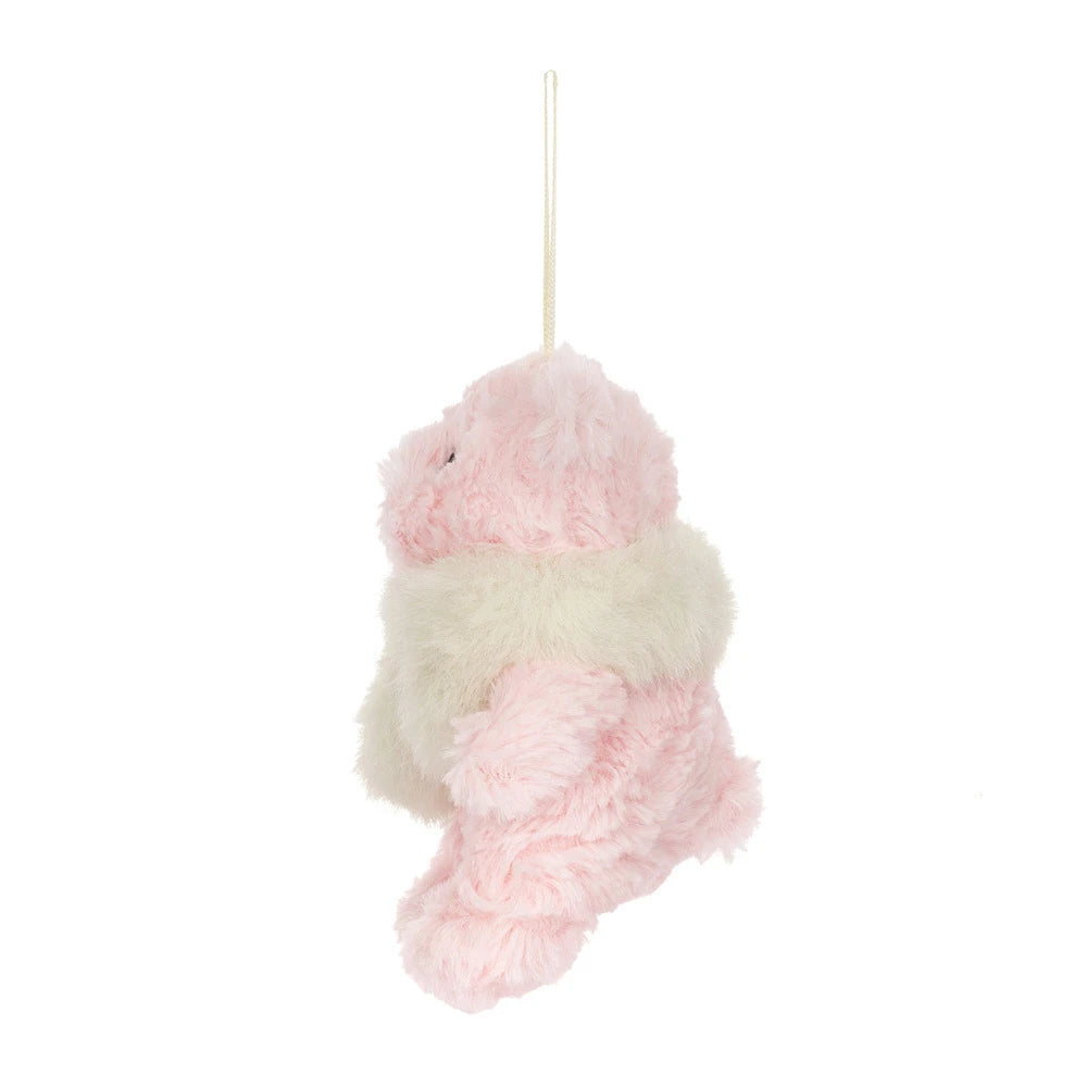 The side of a  small pink plush hanging bear ornament in soft pink and cream white faux fur, suspended by a cream ribbon on a plain white background.
