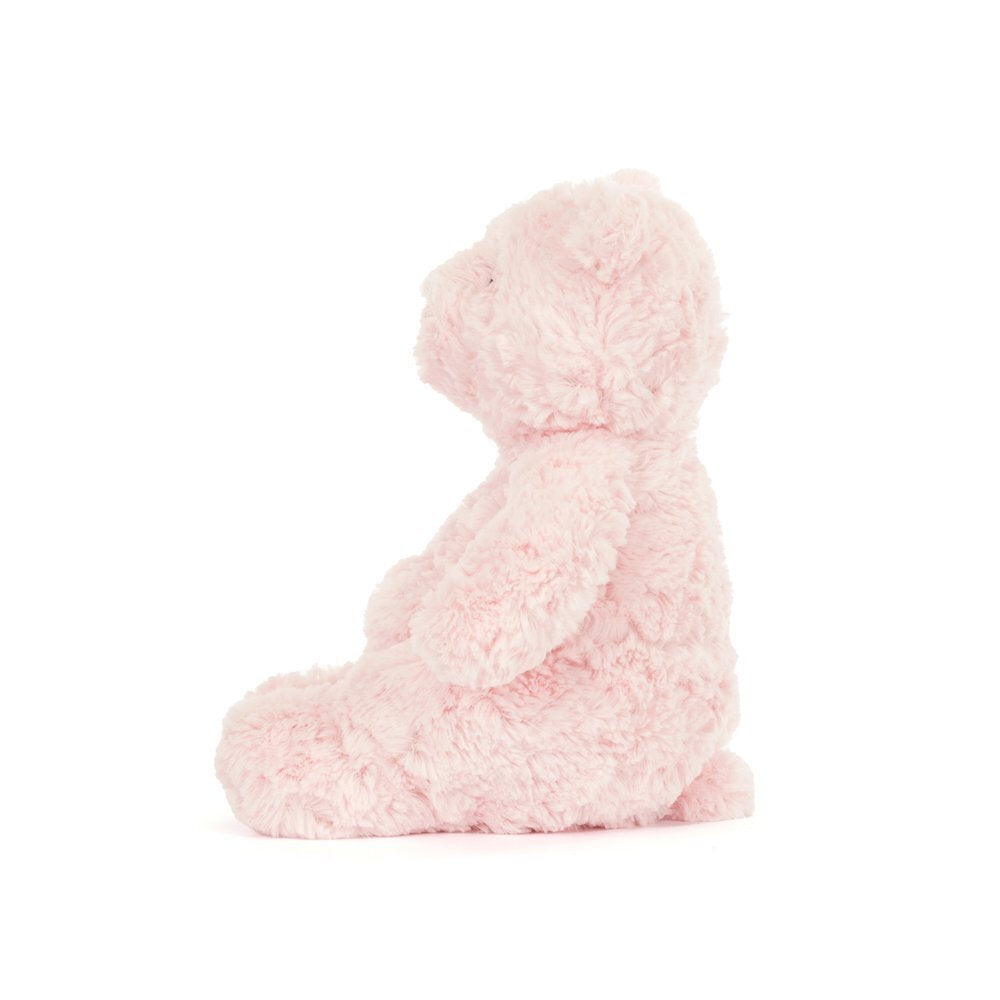 A photo of the side of a pink teddy bear plush toy on a white background.