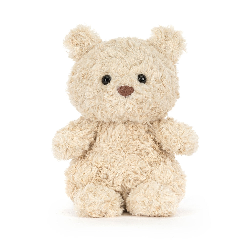 Small beige teddy bear on a white background.