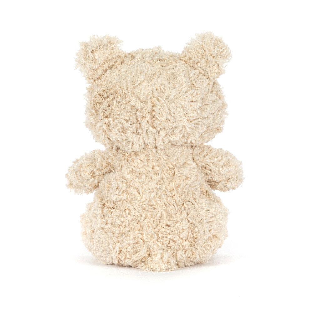 The back of a fluffy beige teddy bear on a white background.