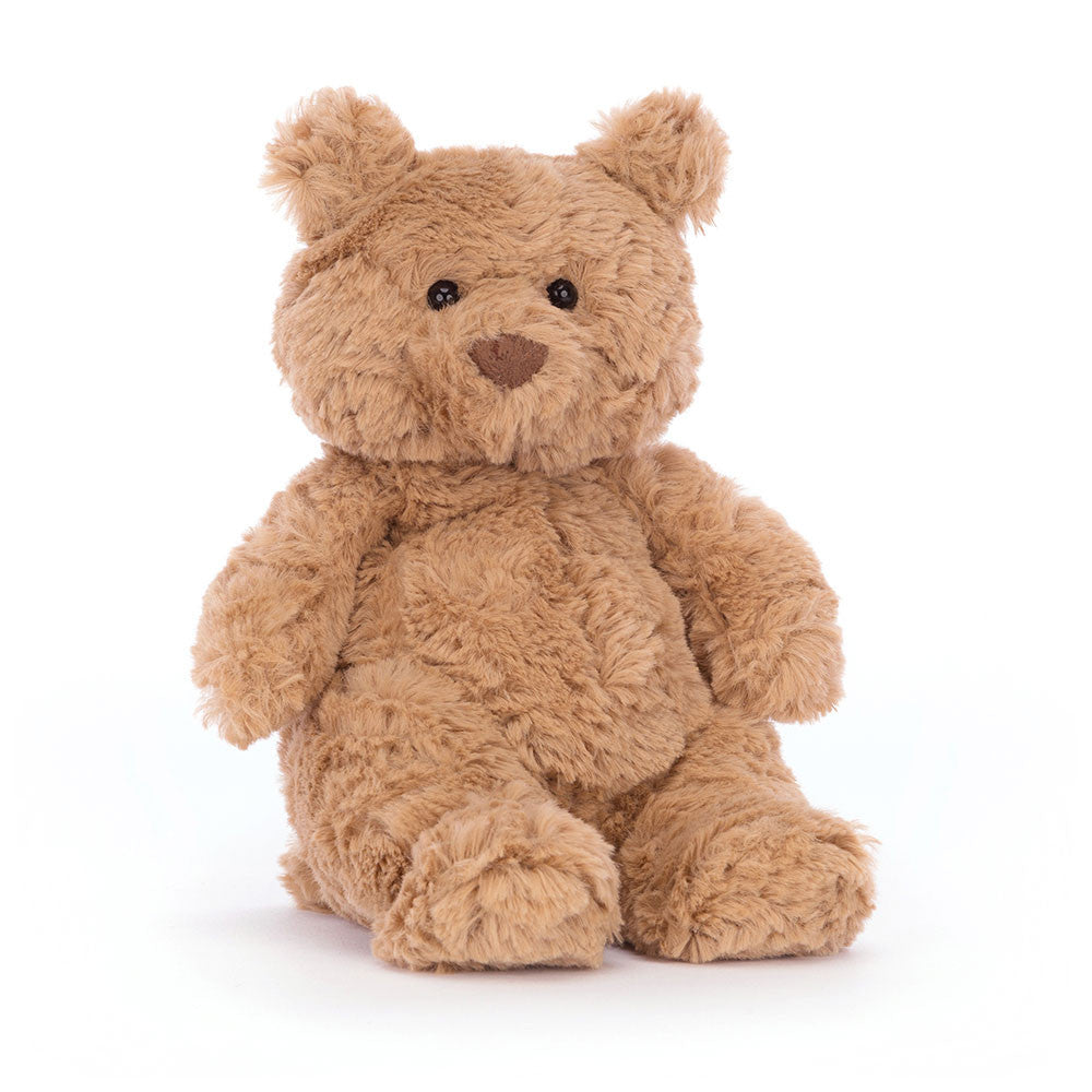 A tiny size beige teddy bear sitting upright on a white backround.