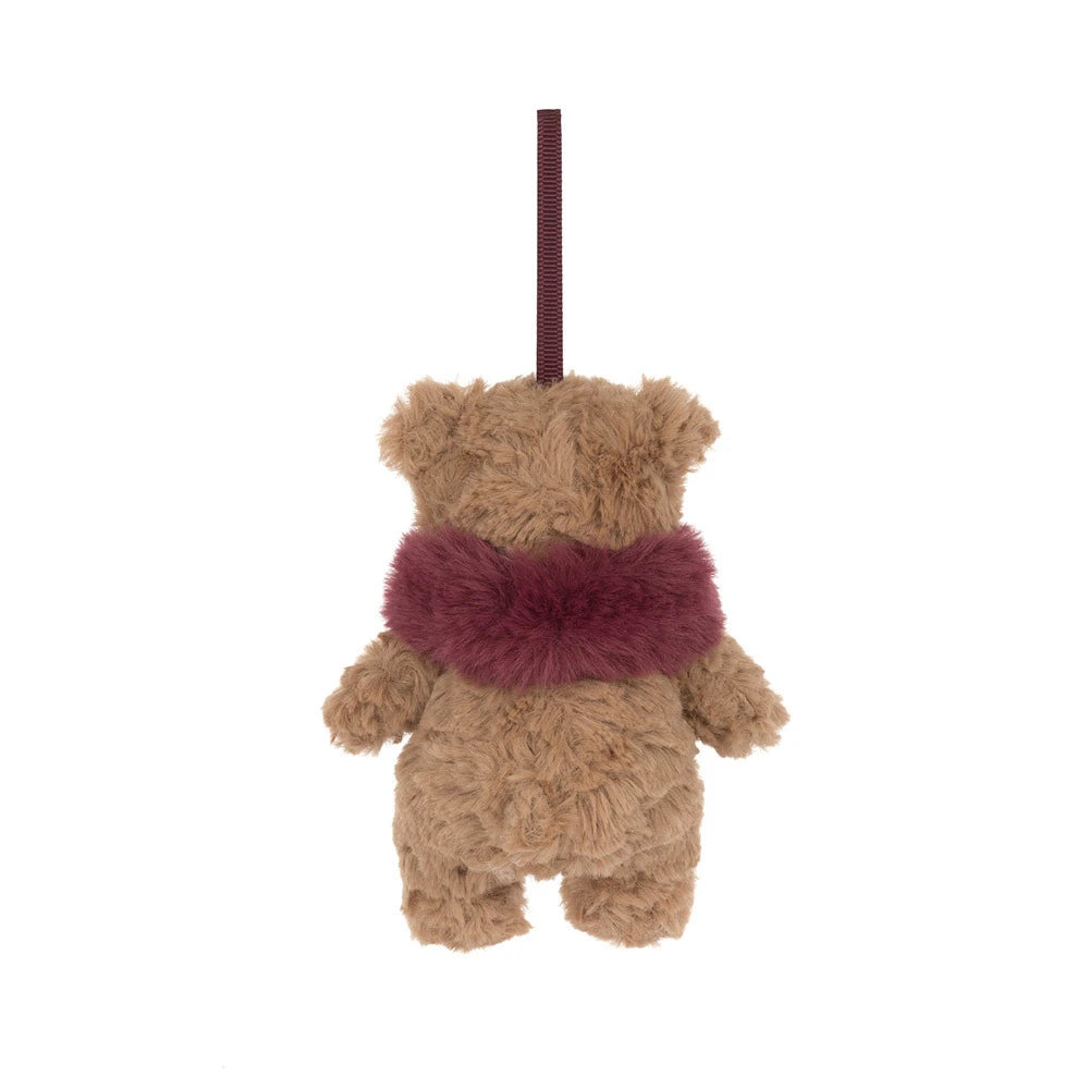 The back of a  small plush teddy bear ornament or hanging decoration in tan with a fuzzy burgundy scarf and a matching hanging loop, shown on a plain white background.
