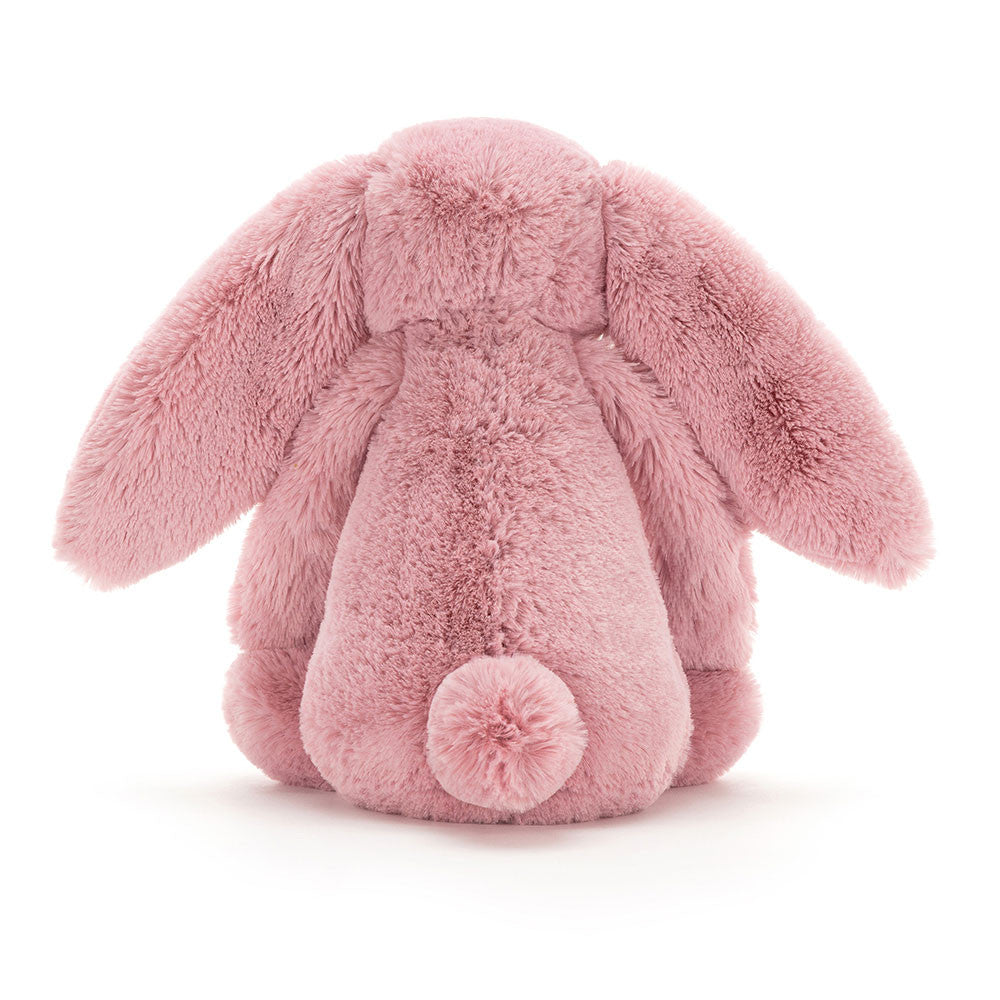 Back of a tulip pink bunny with a gentle expression, sitting upright.