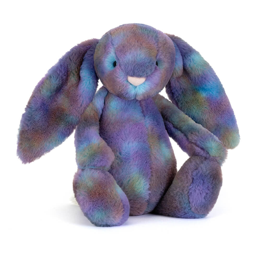 Angled side facing photo of a purple multicolored plush bunny on a white background.