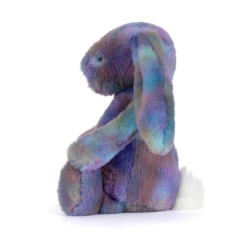 Right side facing photo of a purple multicolored plush bunny toy on a white background.