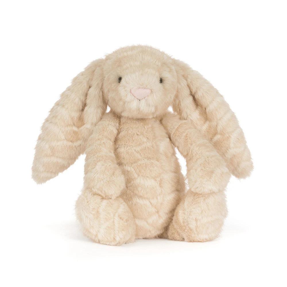 A plush stuffed bunny toy in a light cream-beige color with a soft, textured fur-like surface, long floppy ears, small black embroidered eyes, and a pink stitched nose, shown against a plain white background.