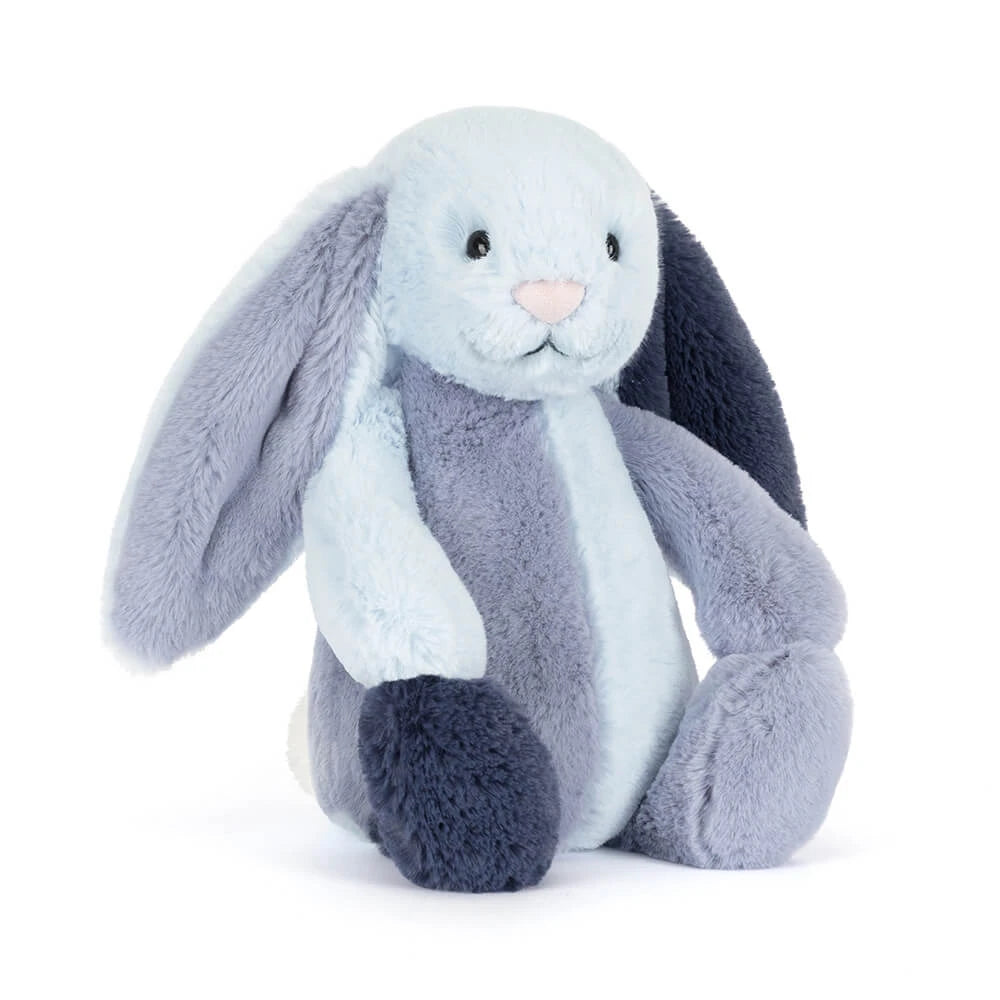 Angled side photo of a colorful blue striped bunny in differant shades of blue on a white backround 