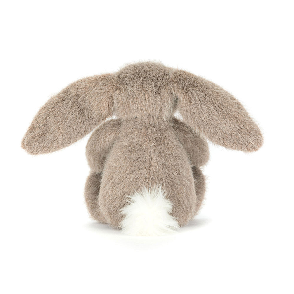 A  photo of the back of a dark beige plush bunny toy with long ears on a white background.