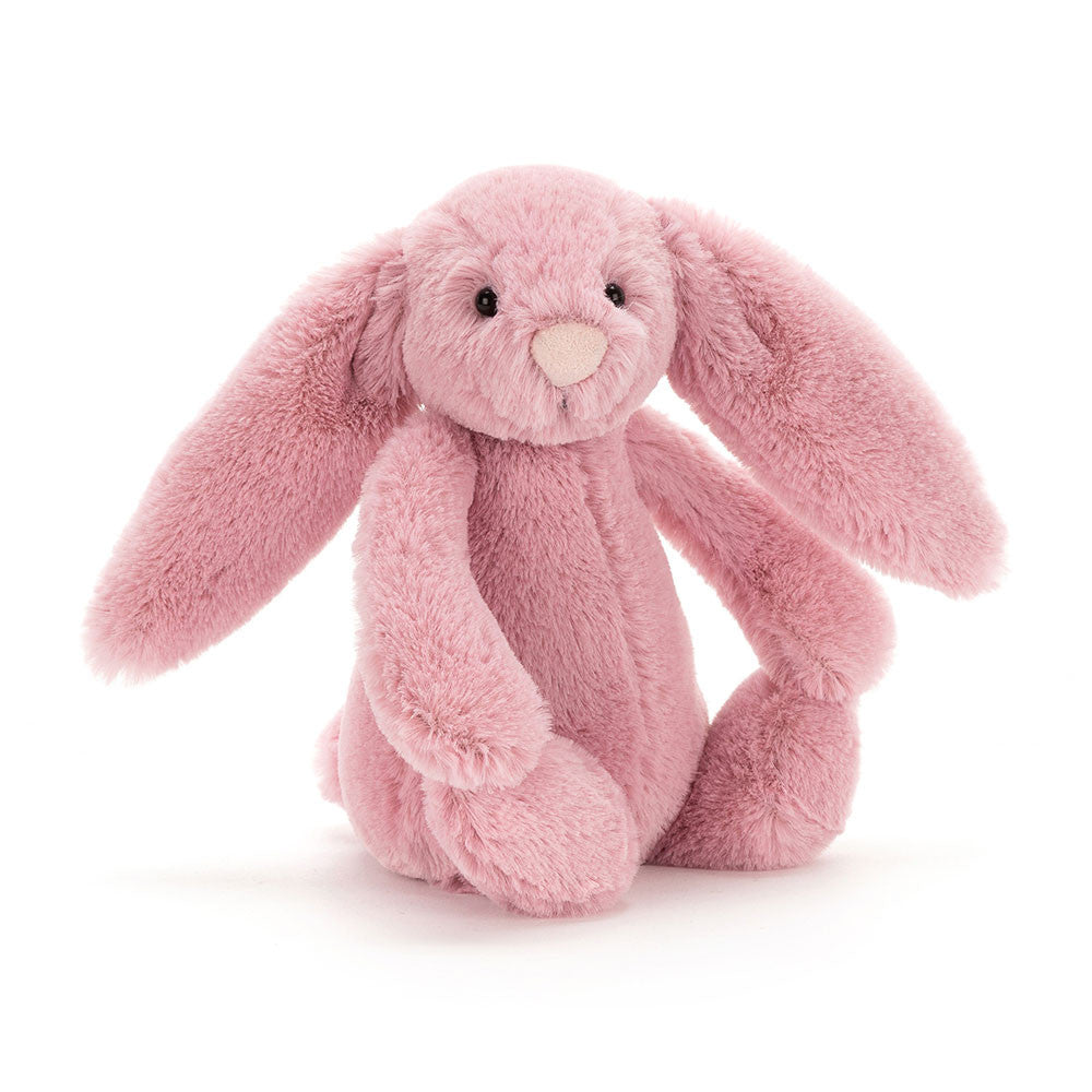 Angled of a tulip pink bunny with a gentle expression, sitting upright.