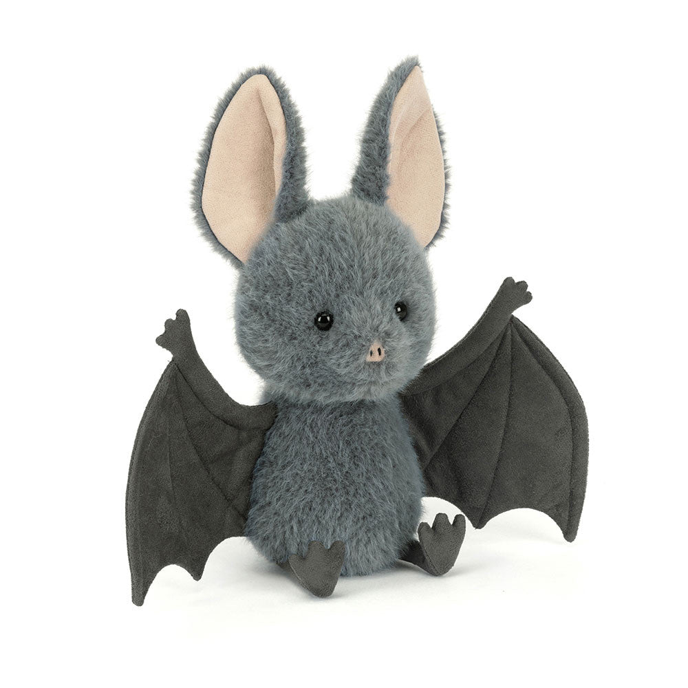 Side angled photo of a stuffed bat toy with gray fur and black wings on a white background.