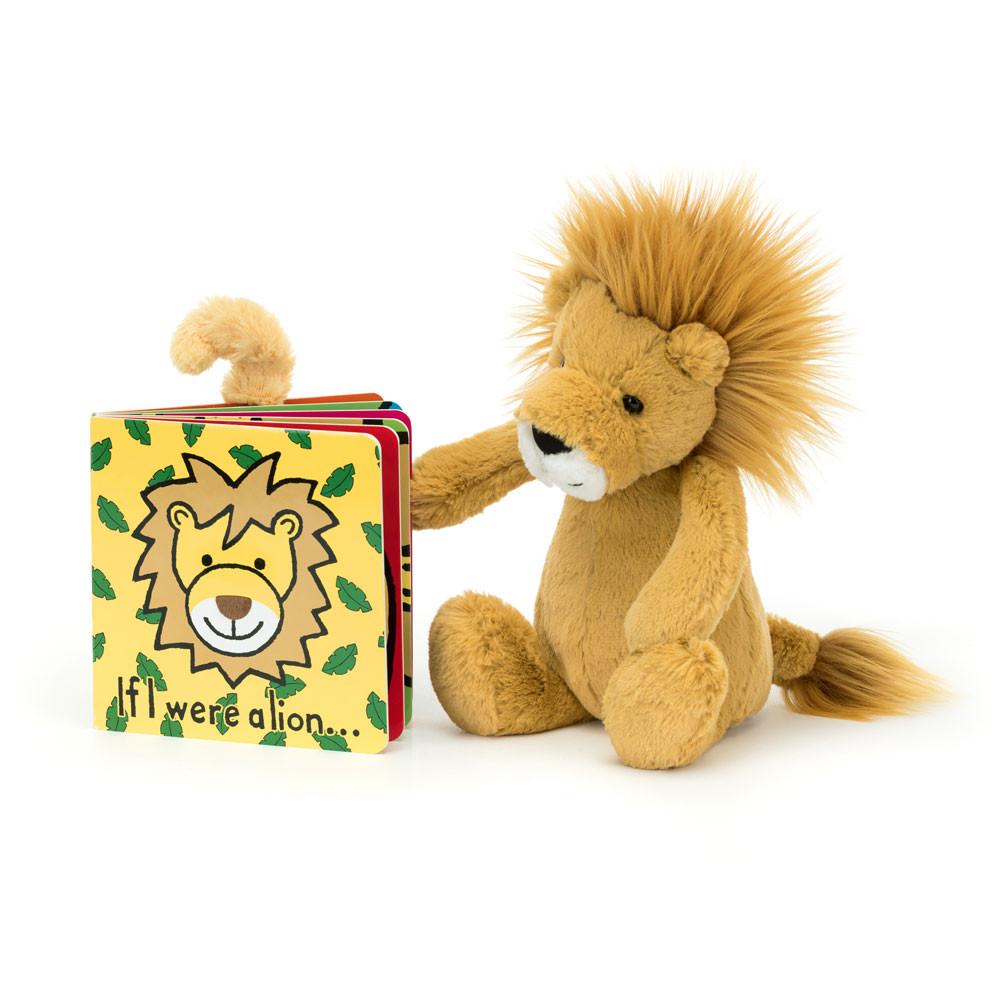 Plush lion toy next to a children's book with a lion illustration on a white background