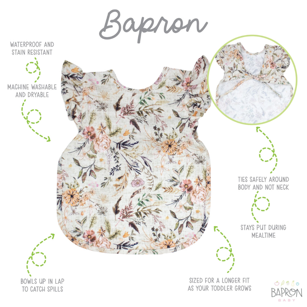 Floral baby apron with features listed on a white background