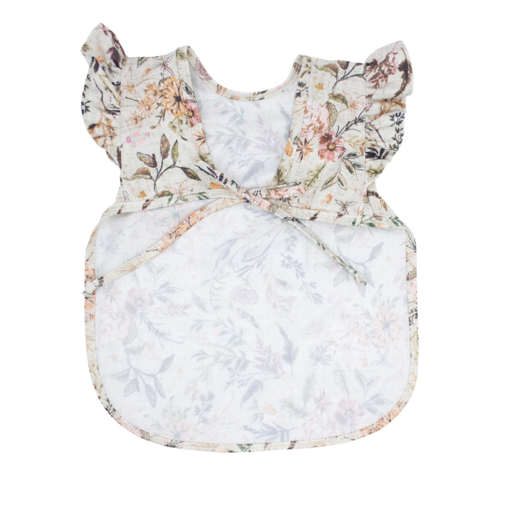 Floral-patterned baby bib-apron on a white background