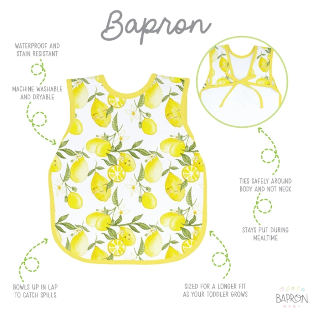 Children's apron with lemon pattern on a white background, featuring text about apron features.