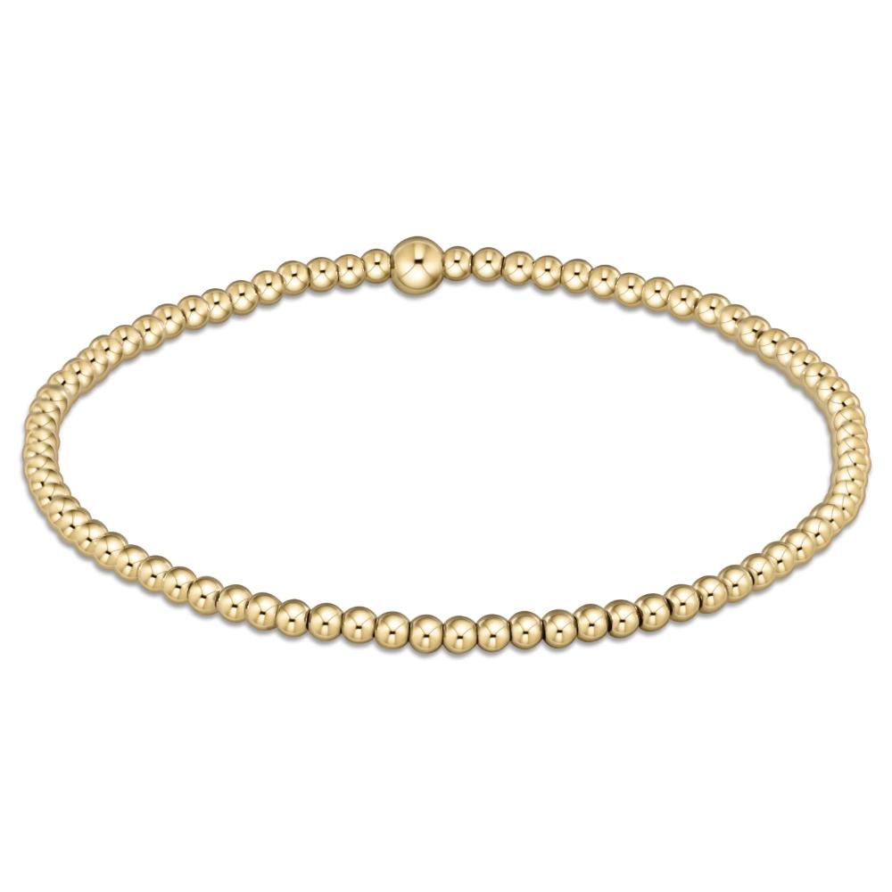 Gold beaded bracelet on a white background
