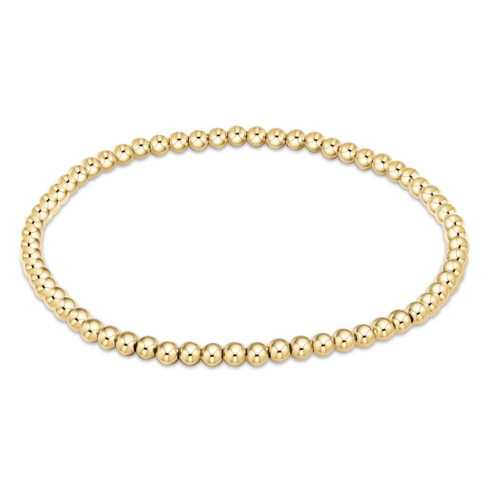 Gold beaded bracelet on a white background