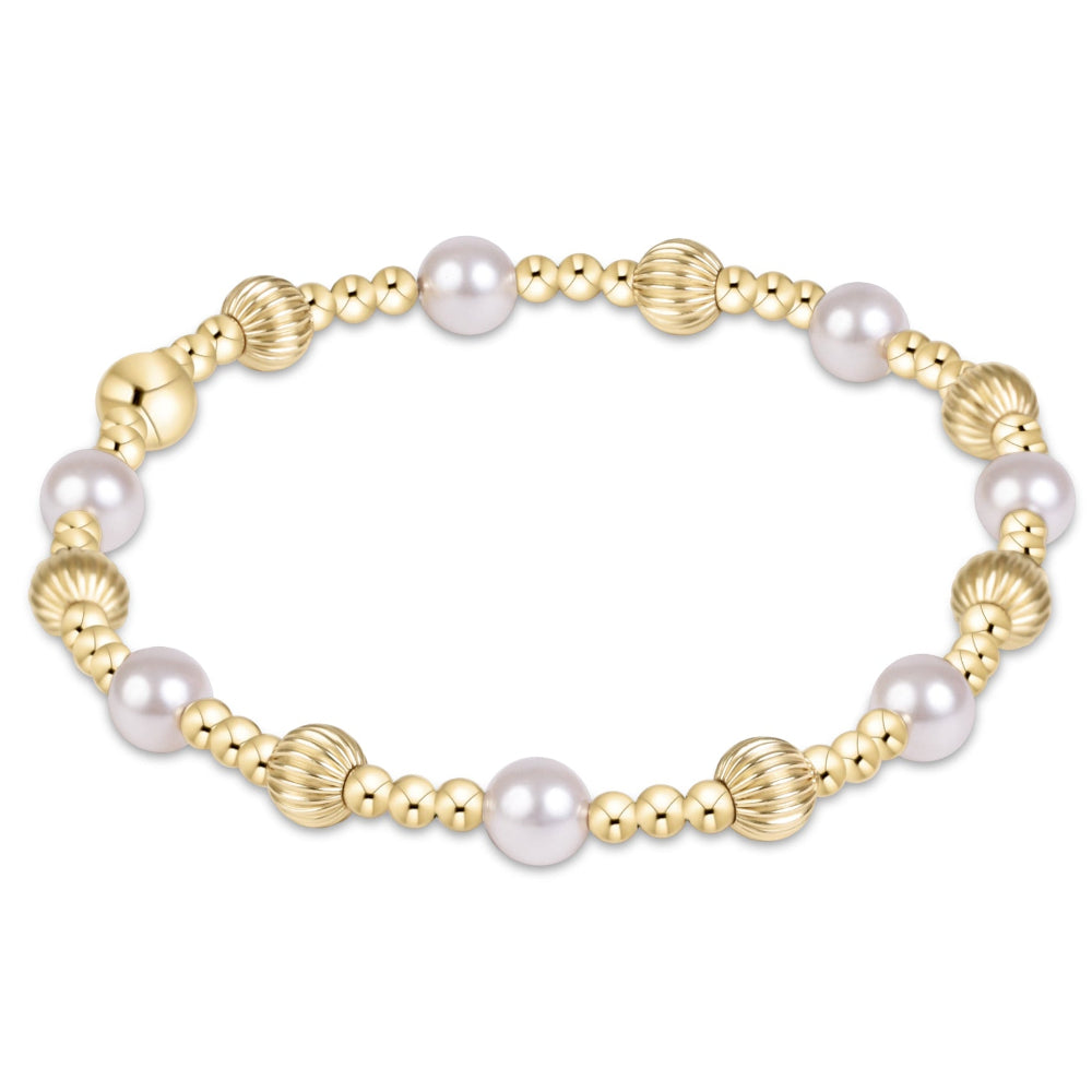 A gold-plated beaded stretch bracelet featuring round white freshwater pearls and textured, ribbed gold beads, displayed on a clean white background.