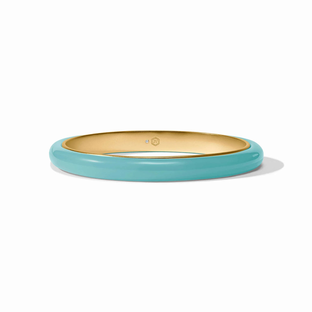 Gold and turquoise bangle on a white background