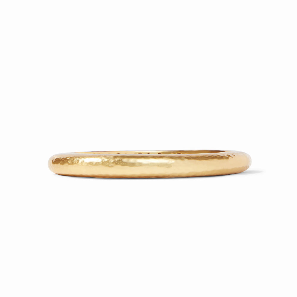 Gold bangle bracelet on a white background