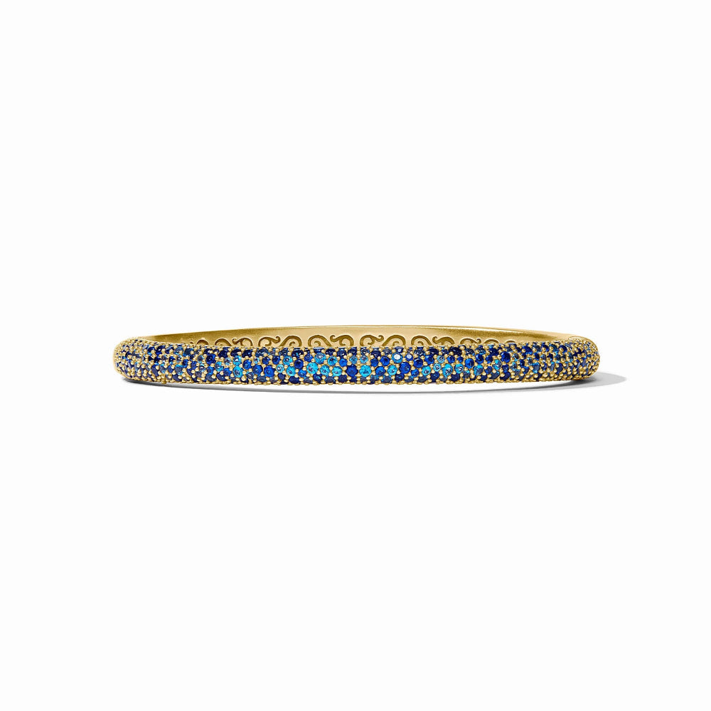 Gold bangle with blue stones on a white background
