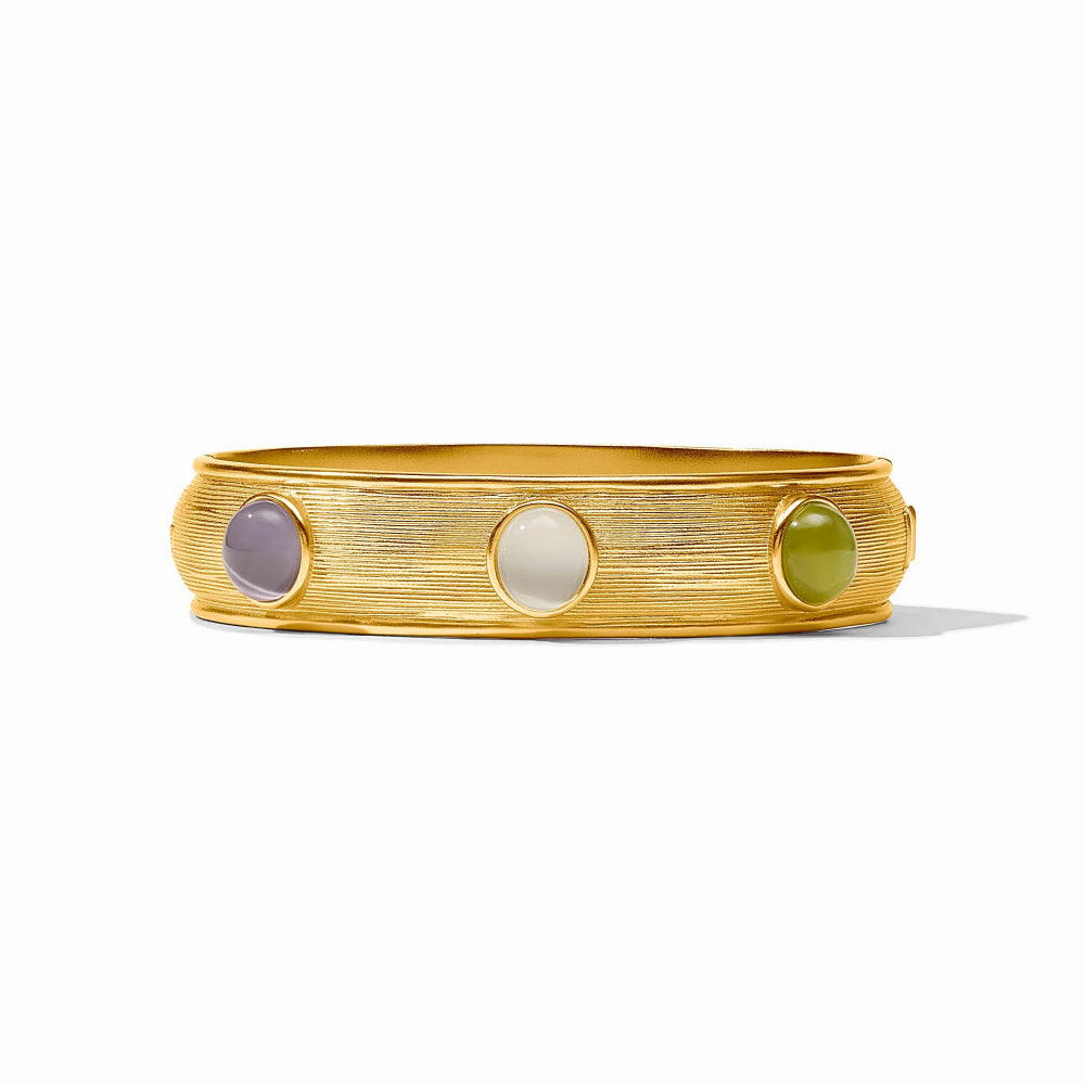 A textured gold bangle bracelet featuring three smooth, bezel-set oval gemstones in lavender, cream, and olive green, displayed on a clean white background.